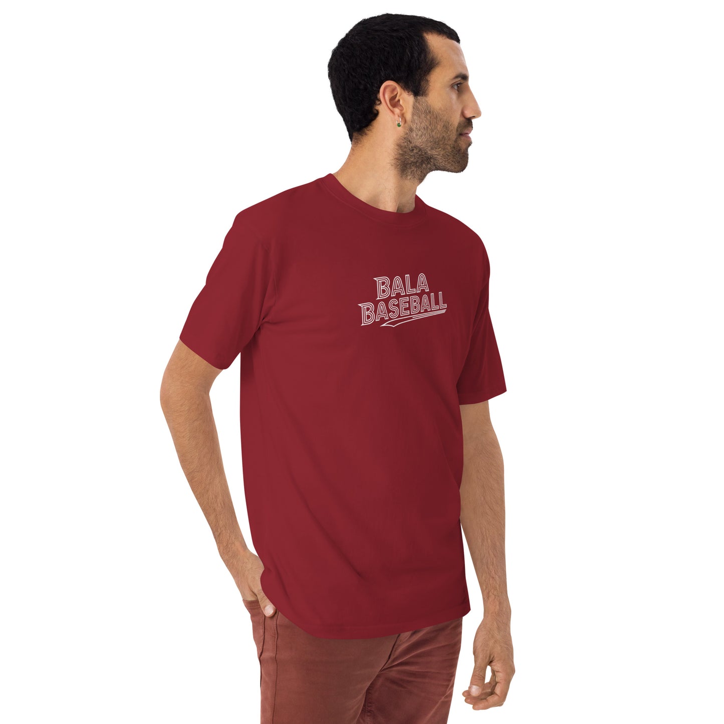 Man wearing a red Beast Mode Activated men’s premium heavyweight tee, featuring a baseball design with "Bala Baseball" text.